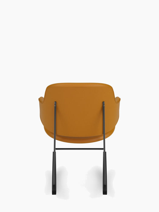 Back view of The Penguin Rocking Chair, Fully Upholstered in tan Dakar leather with a slim, black powder-coated steel frame.