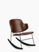 Angled view of The Penguin Rocking Chair, fully upholstered in brown leather, with a black steel frame and black rockers.