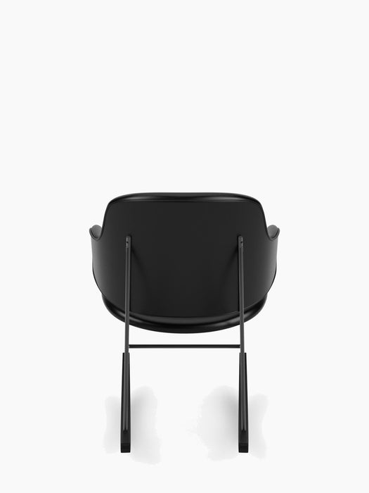 Back view of The Penguin Rocking Chair, fully upholstered in black Dakar leather with a slender black steel frame.