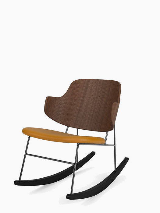 The Penguin Rocking Chair shown at an angle, with a walnut veneer back, mustard-yellow leather seat, and black steel frame.