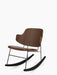 Angled product shot of The Penguin Rocking Chair with a walnut veneer back and brown leather seat on a black steel frame.