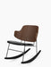 The Penguin Rocking Chair with a dark walnut veneer backrest, a black leather seat, and a black steel frame.