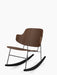 The Penguin Rocking Chair in walnut with a black metal frame and rockers, pictured at an angle against a white background.