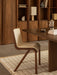 A Ready Dining Chair at an Androgyne Dining Table, with a Nonna Lamp and Convergence Bookends on shelves behind.