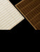 Close-up detail of two rugs against a black background: one light beige, one dark brown, both with a tufted grid pattern.