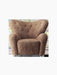 Front view of The Tired Man Lounge Chair in Sahara sheepskin, with a high back, button tufting and plush arms.
