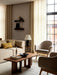 The Torso Table Lamp sits beside an Eave sofa in a living room with an Androgyn Lounge Table and Harbour Lounge Chairs.