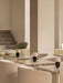A lounge with Torso Portable Table Lamps on Nook Dining Tables, surrounded by plush Tearoom Club Chairs in a neutral palette.