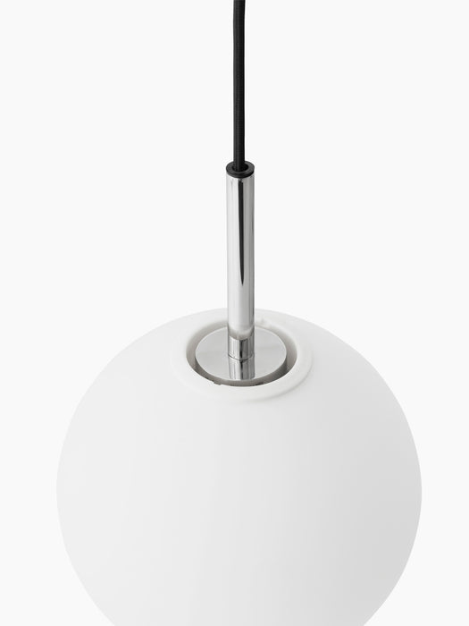 A close-up of the TR Bulb Pendant, showing the polished steel fitting where the black cord meets the white opal glass bulb.