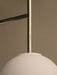 Close-up of the TR Bulb, Suspended Wall Lamp showing the polished steel fixture connected to the large round white opal bulb.