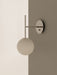 A close-up of the TR Bulb, Suspended Wall Lamp in polished steel, featuring an opal glass bulb, mounted on a two-toned wall.