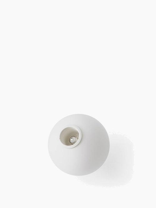 Top-down studio shot of the spherical TR Bulb in matte opal glass, showing its E27 socket against a white background.