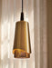 A close-up view of the Umanoff Pendant, featuring a brushed brass shade, a dark walnut top, and glowing perforated diffuser.