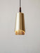 Close-up of the Umanoff Pendant light. The lamp has a brushed brass shade, walnut top, and a glowing perforated diffuser.