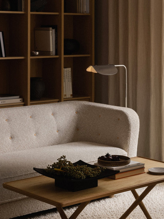 A cosy living room featuring the Vilhelm Sofa, a Jæger Lounge Table with a Relevé Platter, and a Wing Floor Lamp.
