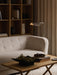 A cosy living room featuring the Vilhelm Sofa, a Jæger Lounge Table with a Relevé Platter, and a Wing Floor Lamp.