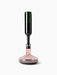 A dark green wine bottle is inverted, decanting red wine through an aerator into the wide-based glass Wine Breather Deluxe.