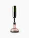 Front view of the Wine Breather Carafe by Norm Architects, with an inverted wine bottle aerating rosé wine into the decanter.