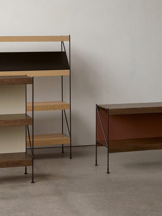 A minimalist setting featuring three variations of the Zet Storage System in different heights, colours and wood finishes