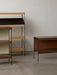A minimalist setting featuring three variations of the Zet Storage System in different heights, colours and wood finishes