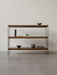 A three-shelf Zet Storage System in dark wood with a black metal frame, decorated with bowls, a teapot, and a sculpture.