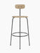 Front view of the Afteroom Bar Chair, Veneer in natural oak with a black powder-coated steel frame, on a black background.