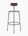 Front view of the Afteroom Bar Chair with a dark wood backrest, a beige upholstered seat, and a slender black steel frame.