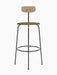 Front view of the Afteroom Bar Chair with a natural oak backrest, a brown upholstered seat, and a slim black steel frame.