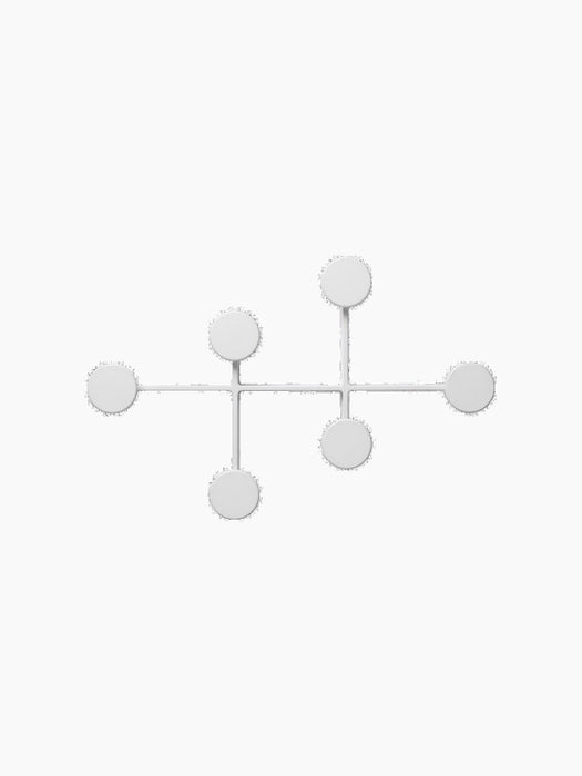 Front view of the white Afteroom Coat Hanger, a minimalist design with six round knobs for hanging, on a black background.