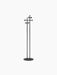 A minimalist black coat stand with a flat circular base, two tall vertical poles, and clusters of round hooks at the top.