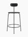 Front view of the Afteroom Counter Chair in black veneer. The chair has a slim metal frame, a round seat, and a low backrest.