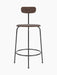 Front view of the Afteroom Counter Chair in dark stained oak veneer, showing its slim black steel frame and wooden seat.