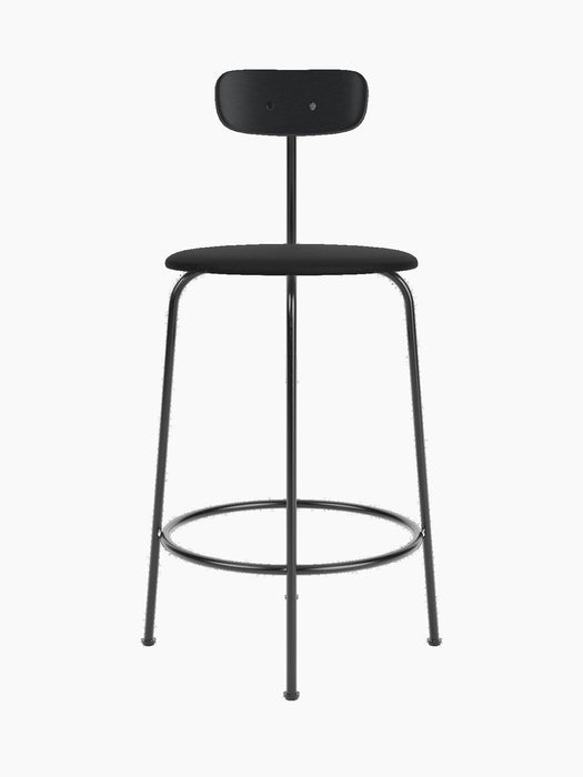 Front view of the minimalist Afteroom Counter Chair in black, with an upholstered seat, steel frame, and low wooden backrest.