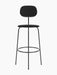 The black Afteroom Bar Chair Plus, Fully Upholstered, front view. It has a slim metal frame, round seat, and oval back.