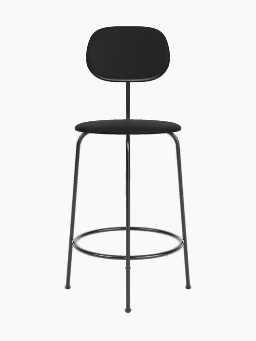A black Afteroom Counter Chair Plus with a textured, upholstered round seat and wide backrest, on a thin black metal frame.