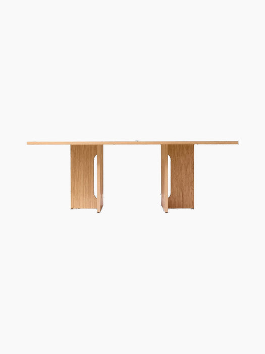 A front view of the Androgyne Dining Table, Rectangular, in natural oak, shown against a black background.