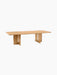 Angled view of the long, rectangular Androgyne Dining Table in natural oak, featuring two wide legs with oblong cutouts.