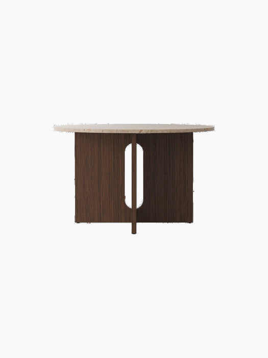 A front-on view of the Androgyne Dining Table, featuring a Kunis Brescia stone top and a dark stained oak base with a cutout.