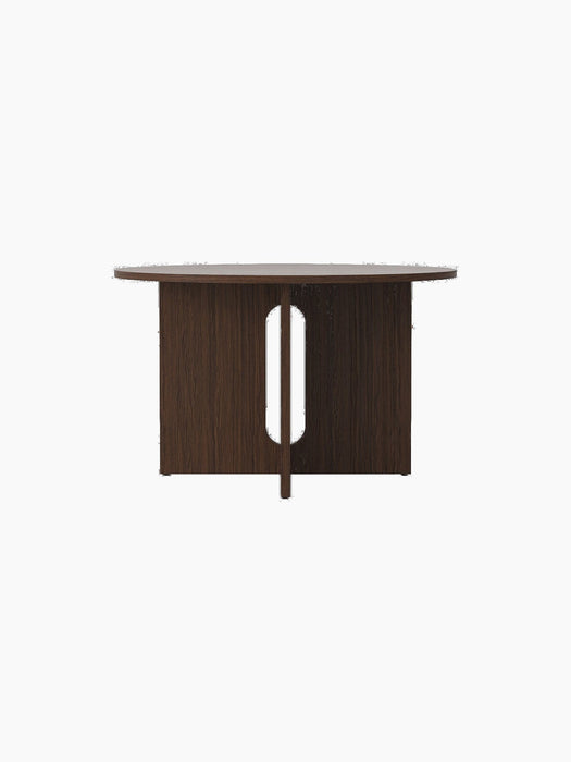Front view of the round Androgyne Dining Table in dark stained oak, featuring its distinctive base with a vertical cutout.