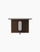 Front view of the round Androgyne Dining Table in dark stained oak, featuring its distinctive base with a vertical cutout.