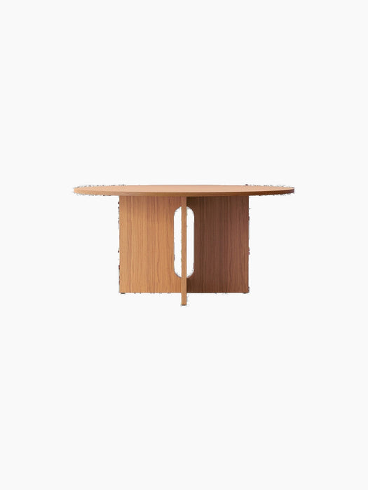 The Androgyne Dining Table in natural oak, shown from the front. The sculptural base has a distinctive vertical oval cut-out.