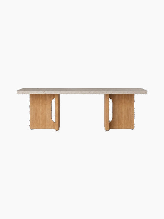 Front-on view of the Androgyne Lounge Table, featuring a rectangular Kunis Breccia stone top and a natural oak wood base.
