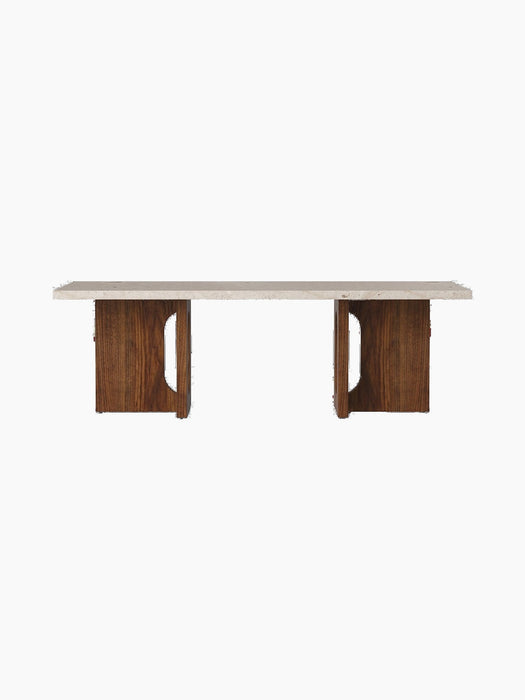 Front view of the Androgyne Lounge Table, featuring a rectangular Kunis Breccia stone top resting on a dark walnut wood base.