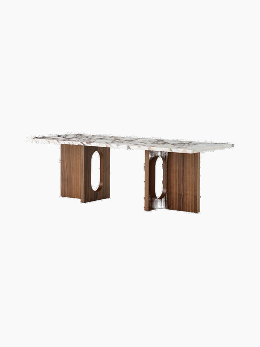 An angled view of the Androgyne Lounge Table, featuring a rectangular Calacatta Viola marble top and a dark walnut wood base.