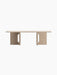 A straight-on shot of the Androgyne Lounge Table in Kunis Breccia stone, with its rectangular top and two wide, cutout legs.