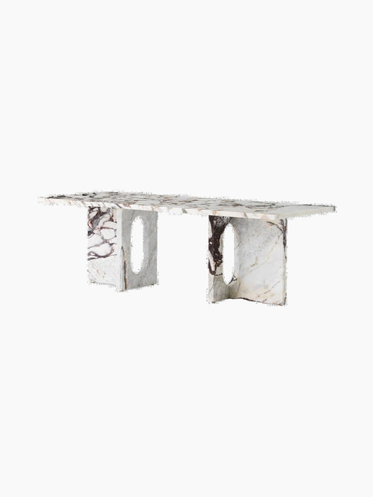 Androgyne Lounge Table in Calacatta Viola marble, with a rectangular top and two wide legs with distinctive oval cutouts.