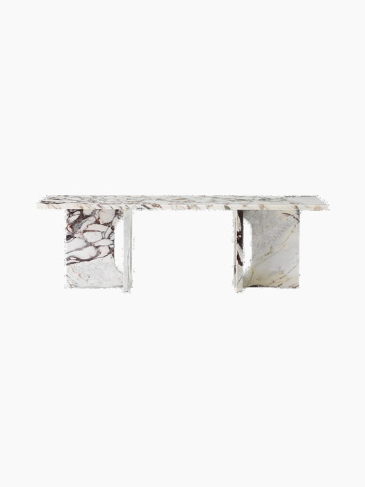 Front-on view of the Androgyne Lounge Table in Calacatta Viola marble, with its rectangular top and two wide, arched legs.
