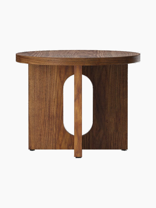 A front view of the Androgyne Side Table, Ø50, in walnut veneer, with its round top and flat-legged base with an oval cutout.