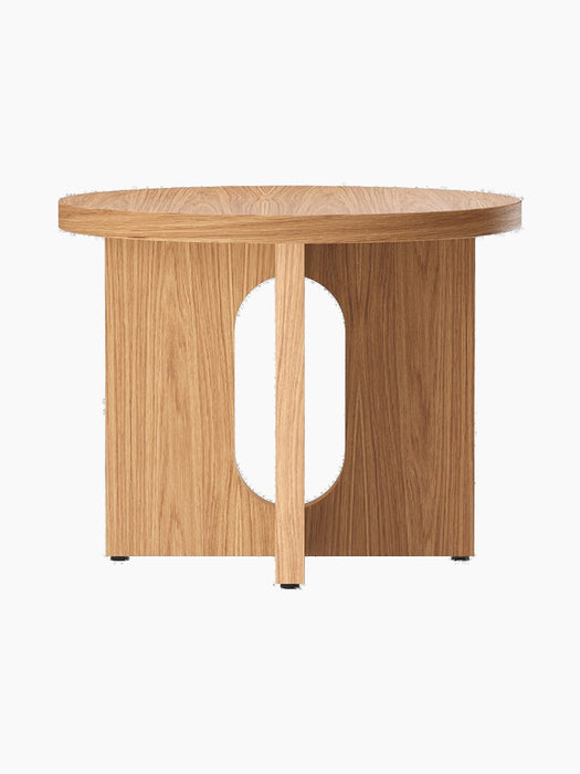 Front view of the Androgyne Side Table, Ø50 in natural oak, showing its round top and distinctive base with an oval cutout.