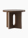 The Androgyne Side Table, Ø50, in dark stained oak. The round table features a base with wide, flat legs and an oval cutout.